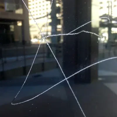 Heavy scratched-graffiti tag — current GlassRenu field photo